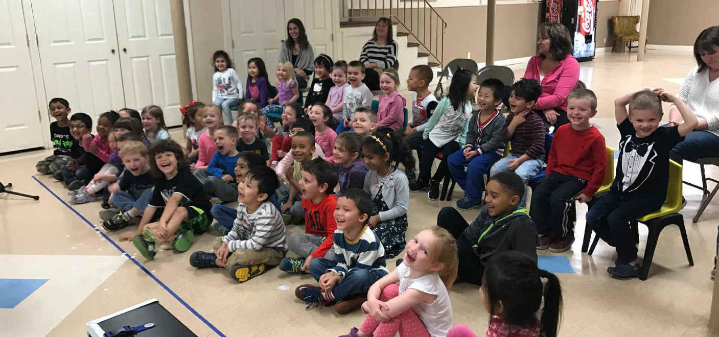 Preschool audience in MA enjoying magic show